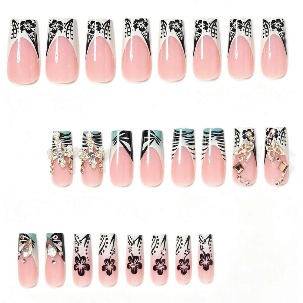 Artistic Stiletto Nail Design with Floral Accents and Gems Acalora