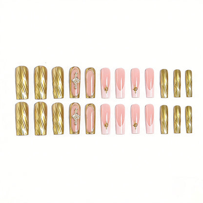 Acrylic nail set with elegant golden embellishments and glamorous accents Acalora