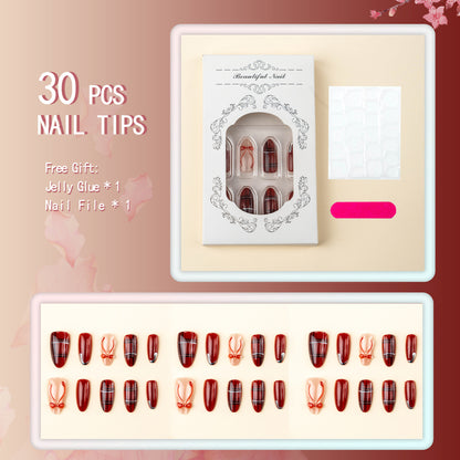 Art nail set with festive design and bow accents Acalora