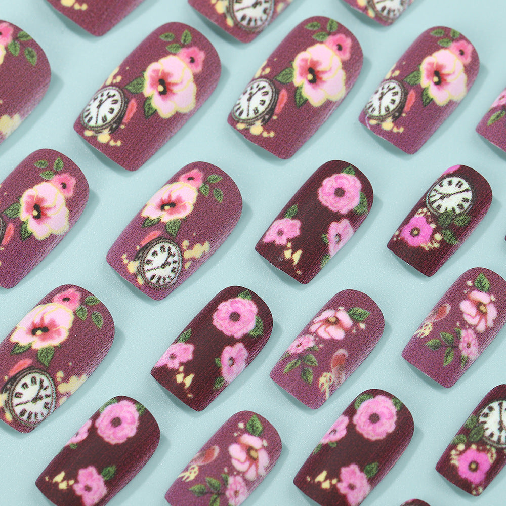 Nail art with floral design and intricate clock motifs Acalora