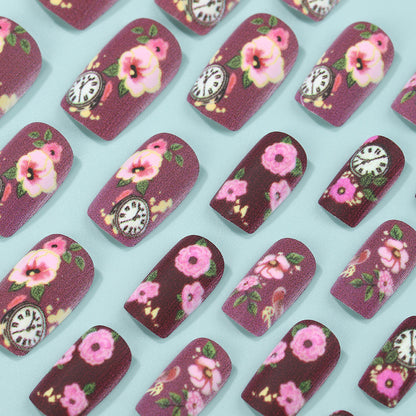 Nail art with floral design and intricate clock motifs Acalora