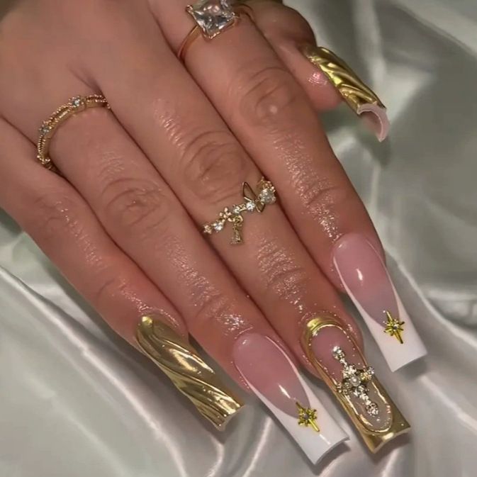 Acrylic nail set with elegant golden embellishments and glamorous accents Acalora