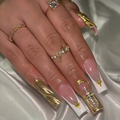 Acrylic nail set with elegant golden embellishments and glamorous accents Acalora