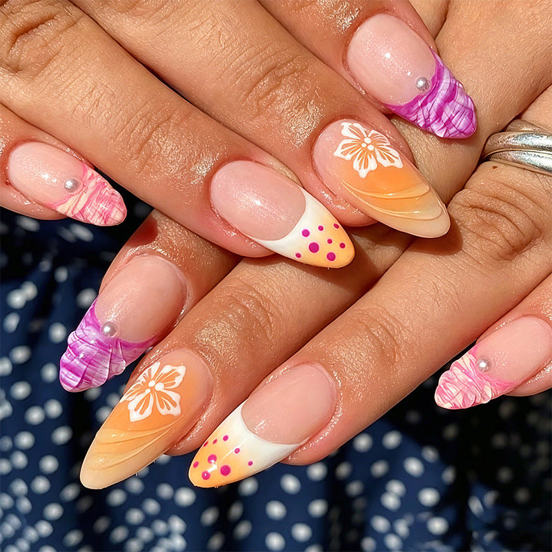 Acrylic nail set with exotic flower patterns and glitter accents Acalora