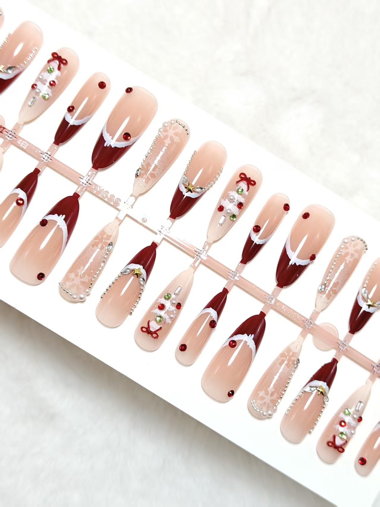 Artificial nails with festive designs and glitter accents Acalora