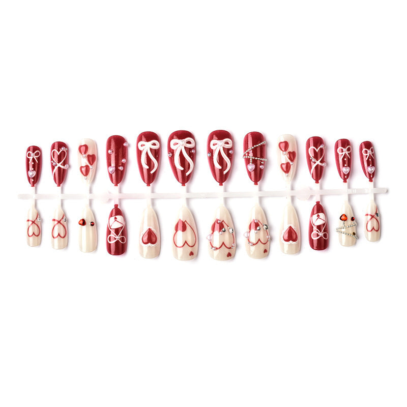Glamorous artificial nail set with romantic heart design and elegant embellishments Acalora