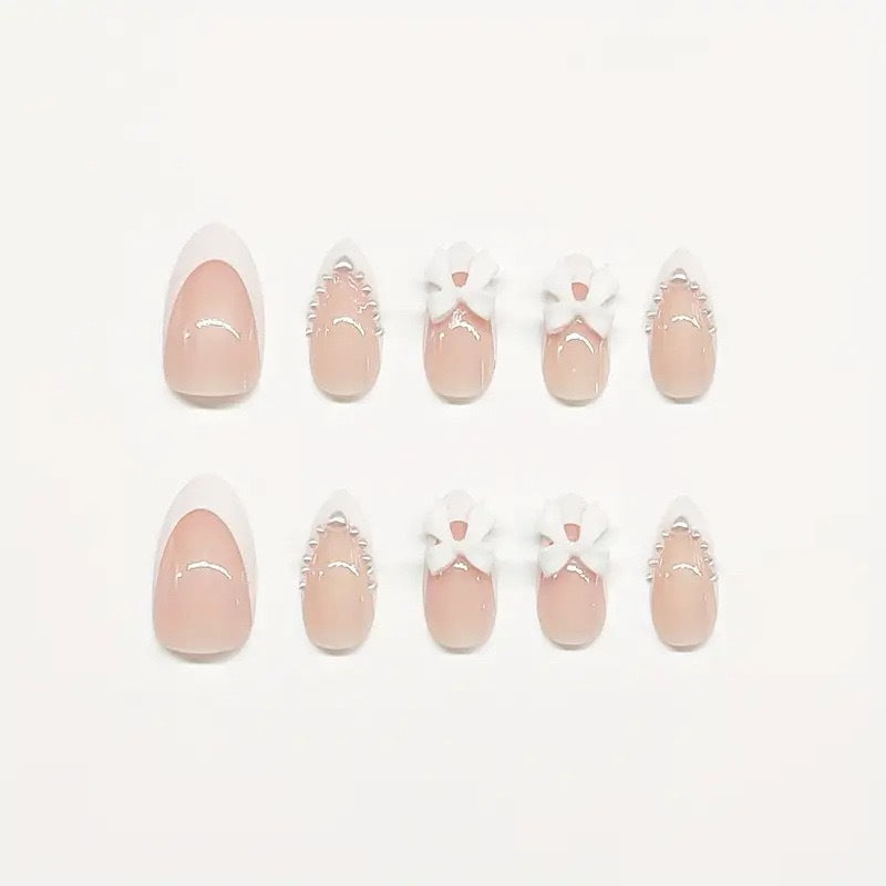 Artistic Press-On Nail Design with Bow Accents Acalora