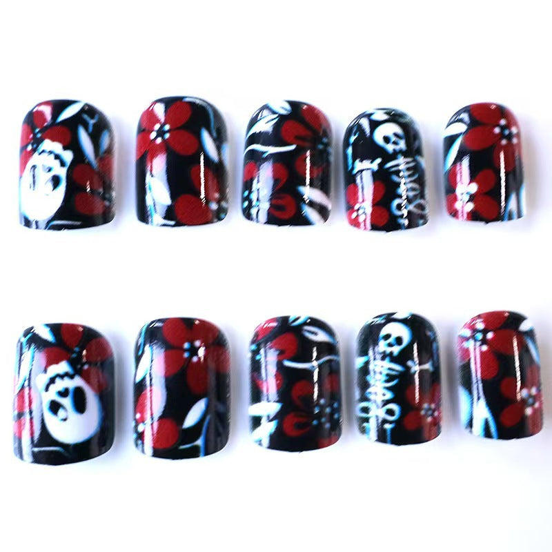 Artificial nail set with creepy skull design and floral accents Acalora