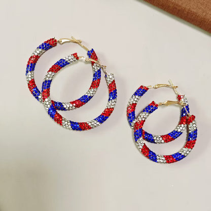 Women's handcrafted crystal pavé hoop earrings with curved tube element and clasp closure Bowlift