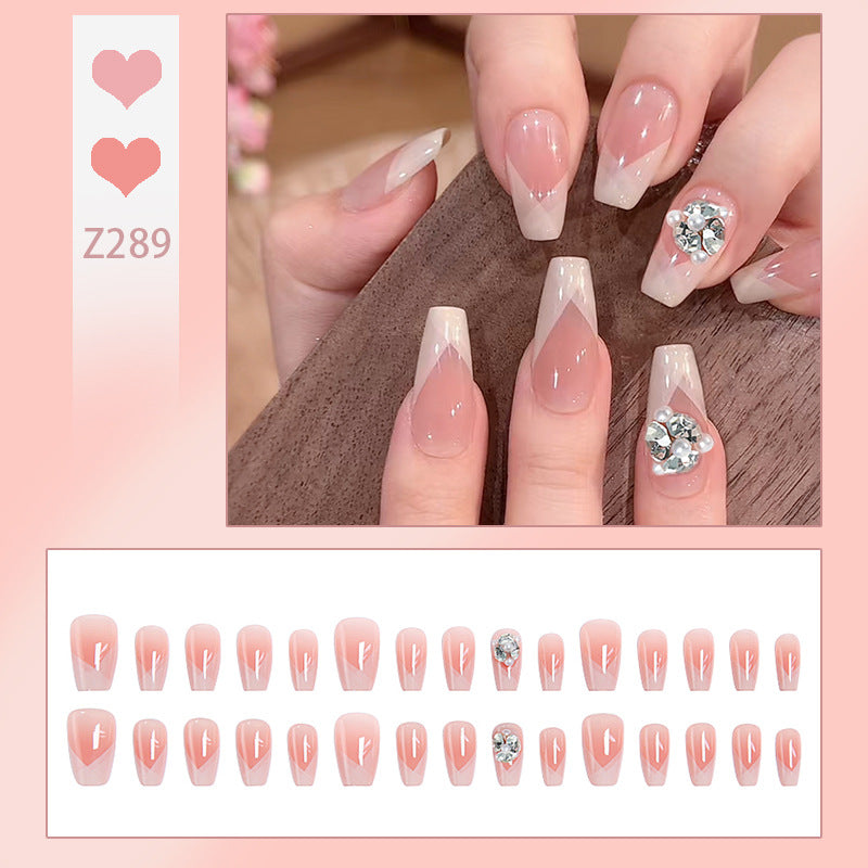 Artificial nail set with filigree tip designs and glamorous rhinestone accents Acalora