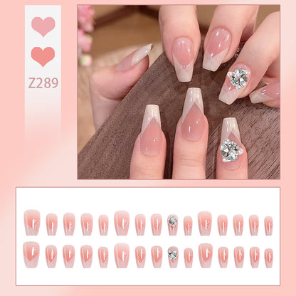 Artificial nail set with filigree tip designs and glamorous rhinestone accents Acalora