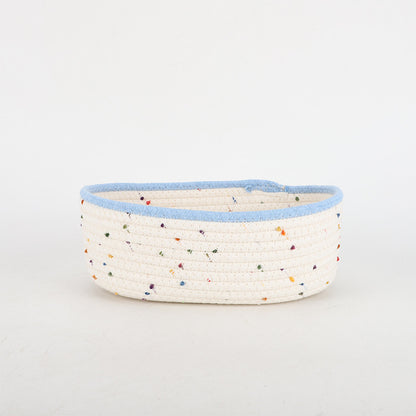 Storage basket made of natural cotton fabric with colorful dots
