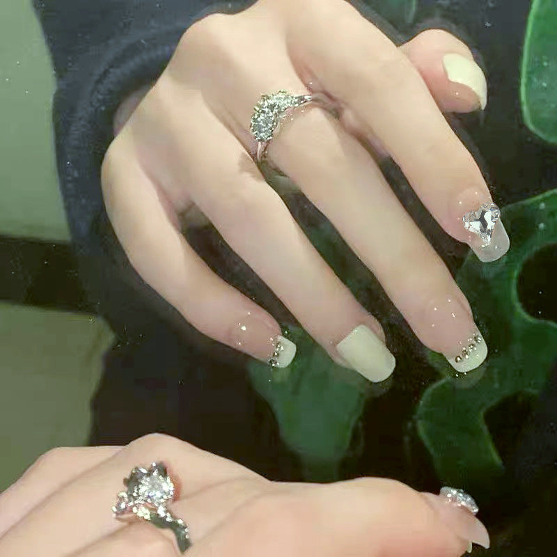 Glamorous artificial nails with heart and rhinestone decorations Acalora