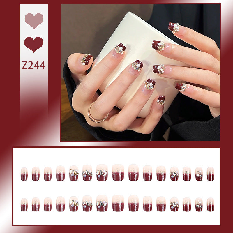 Glamorous artificial nails with decorative pearl and glitter embellishments Acalora