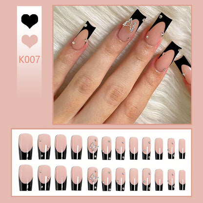 Acrylic nail set with elegant black and white design and glitter accents Acalora