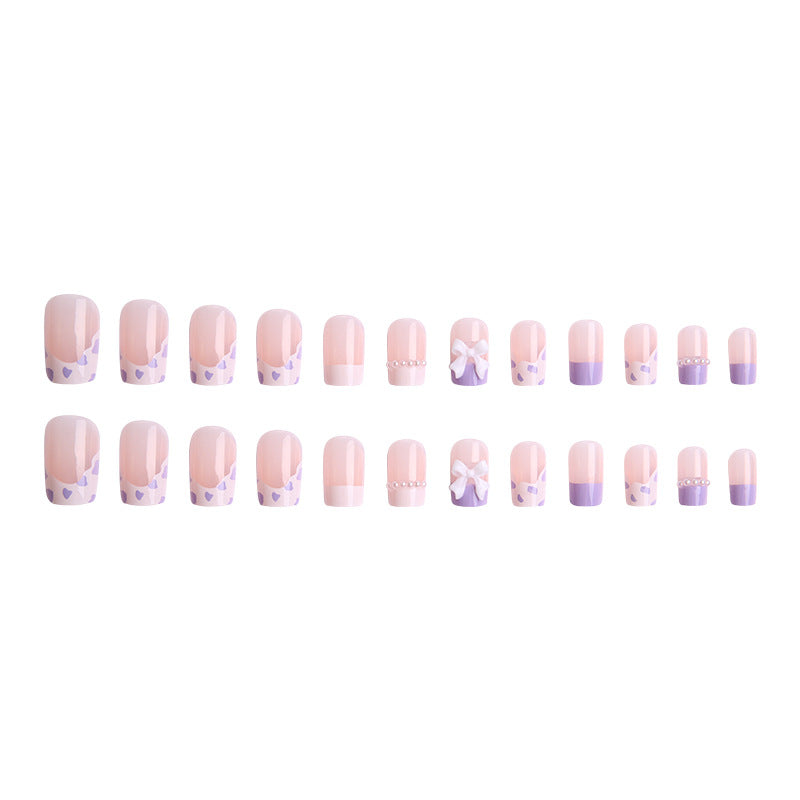 Nail art set with elegant wave patterns and delicate pearl accents Acalora