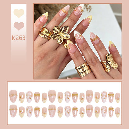 Artificial nail set with enchanting floral details and luxurious gold accents Acalora