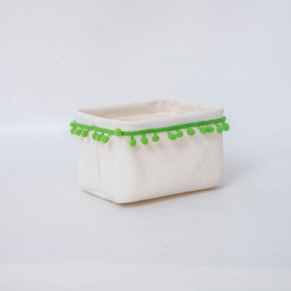 Storage basket with decorative pom-pom trim