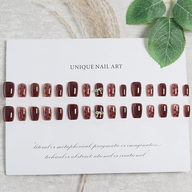 Nail set with elegant leopard pattern and luxurious accents Acalora