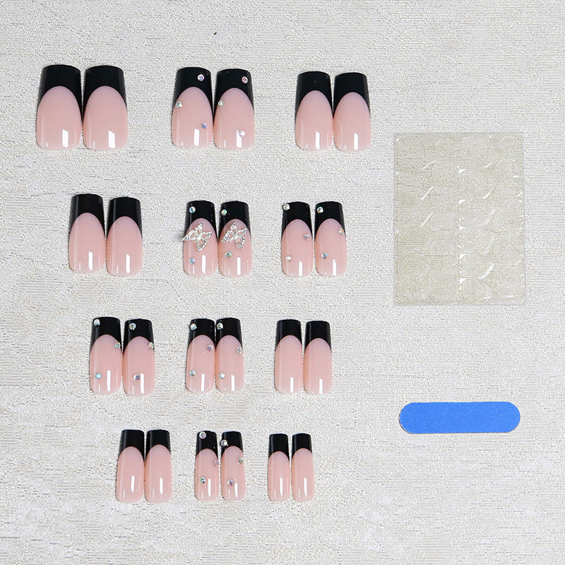Acrylic nail set with elegant black and white design and glitter accents Acalora