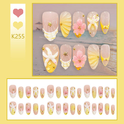 Artificial nail set with glamorous floral designs and creative glitter accents Acalora