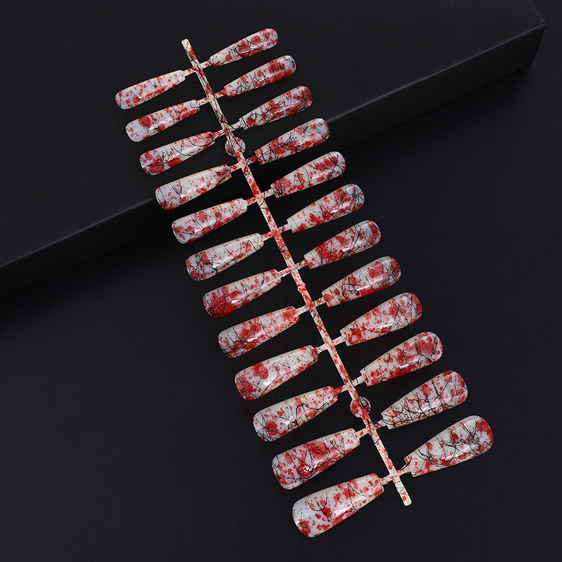 Creative nail art with blood splatter design Acalora