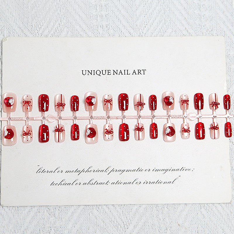 Artificial nail set with festive gift design and elegant glitter accents Acalora