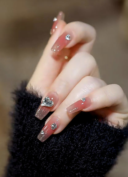 Acrylic nail set with elegant heart and rhinestone decorations Acalora