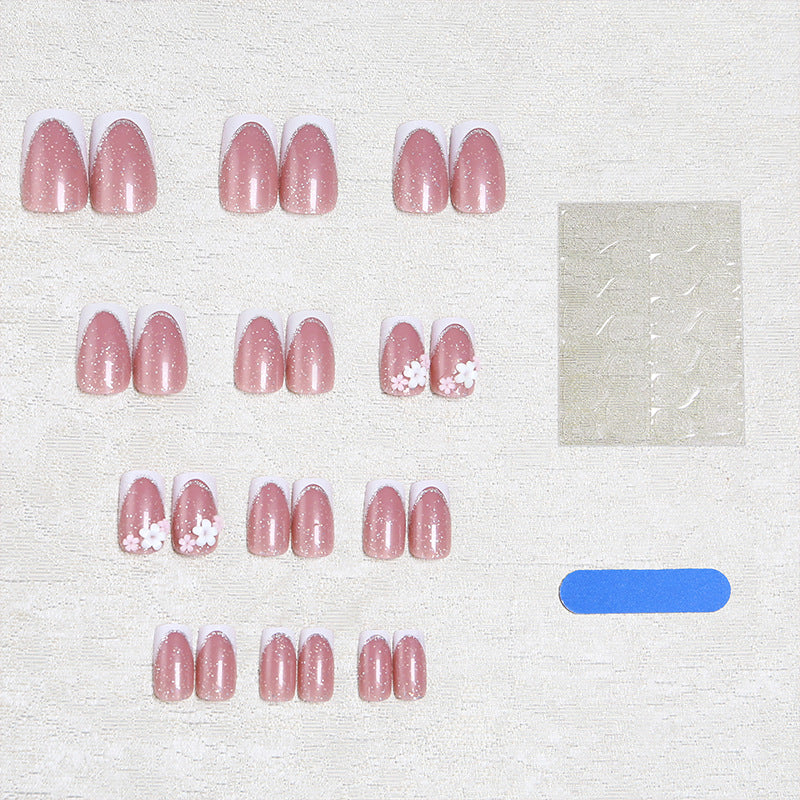 Acrylic nail set with elegant French tip and delicate floral decorations Acalora