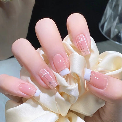 Nail set with elegant French tip and fashionable embellishments Acalora