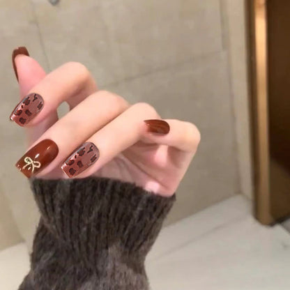 Nail set with elegant leopard pattern and luxurious accents Acalora