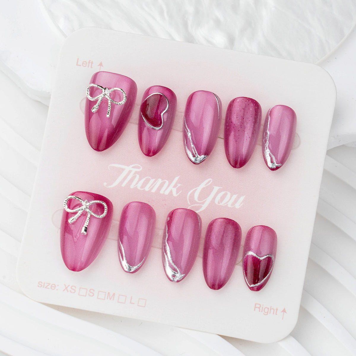 Acrylic nail set with elegant heart and bow decorations Acalora