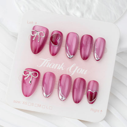 Acrylic nail set with elegant heart and bow decorations Acalora