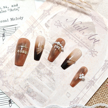 Artificial nails with glamorous gold and pearl embellished accents Acalora