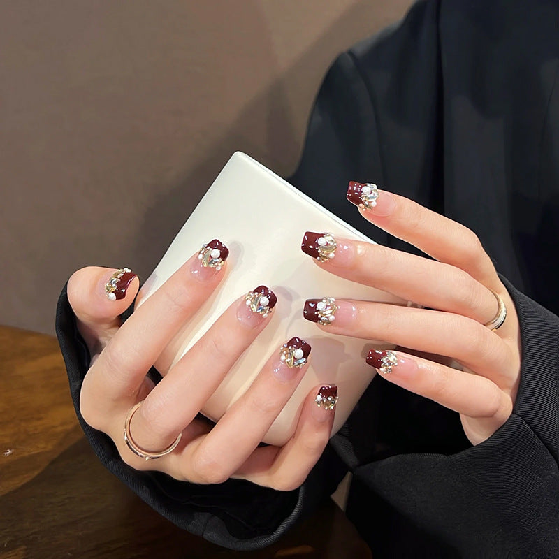 Glamorous artificial nails with decorative pearl and glitter embellishments Acalora