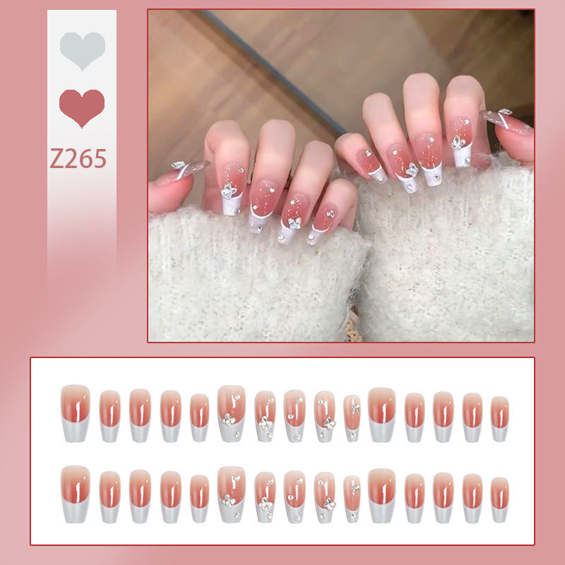 Nail art set with elegant wave patterns and delicate pearl accents Acalora