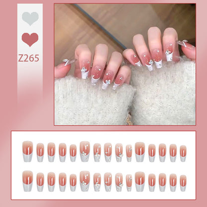 Nail art set with elegant wave patterns and delicate pearl accents Acalora