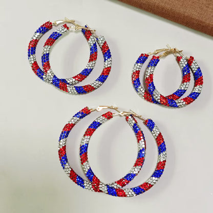 Women's handcrafted crystal pavé hoop earrings with curved tube element and clasp closure Bowlift