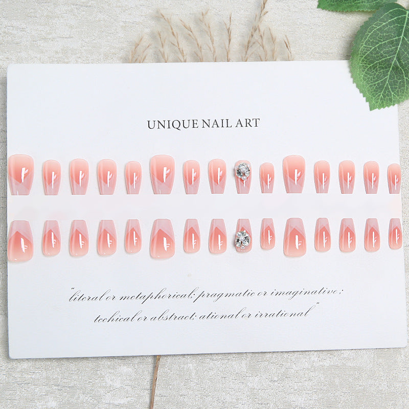 Artificial nail set with filigree tip designs and glamorous rhinestone accents Acalora