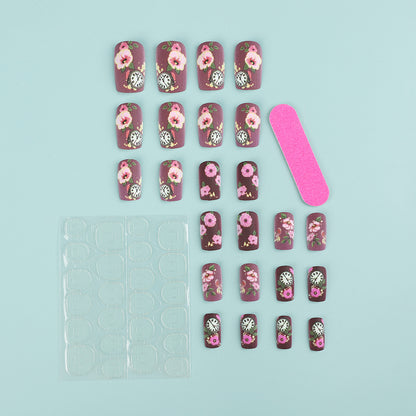 Nail art with floral design and intricate clock motifs Acalora