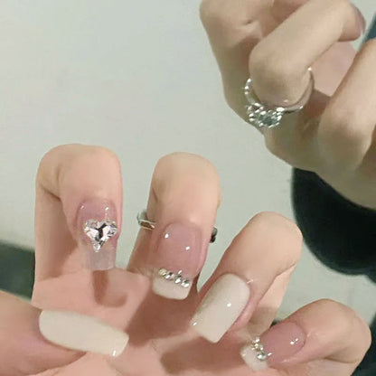 Glamorous artificial nails with heart and rhinestone decorations Acalora