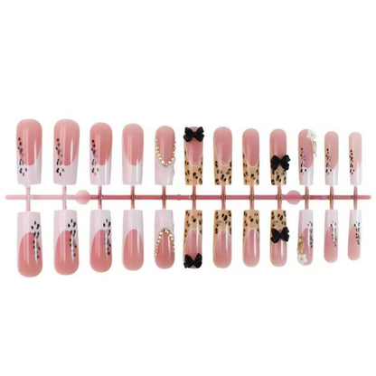 Artistic Press-On Nail Design with Bow and Animal Print Accents Acalora