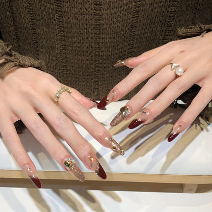 Acrylic nail set with elegant glitter design and exclusive embellishments Acalora