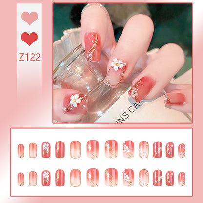 Acrylic nail set with elegant floral decorations and glamorous pearl accents Acalora