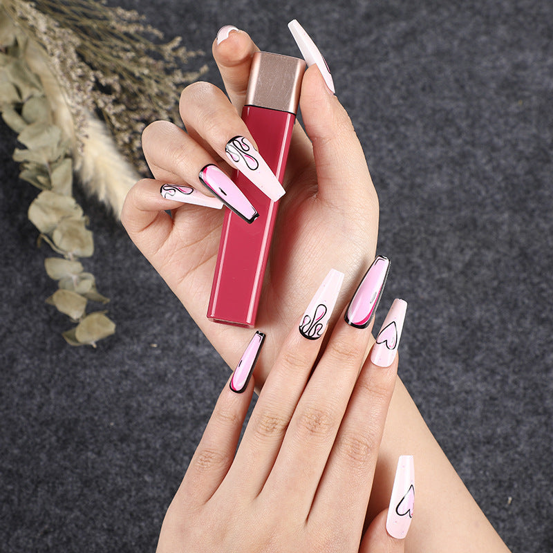 Eye-catching artificial nails with soulful heart design and glamorous accents Acalora