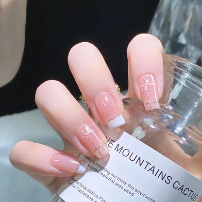 Nail set with elegant French tip and fashionable embellishments Acalora
