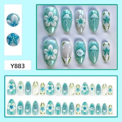 Artificial nails in a maritime design with colorful shell and water motifs Acalora