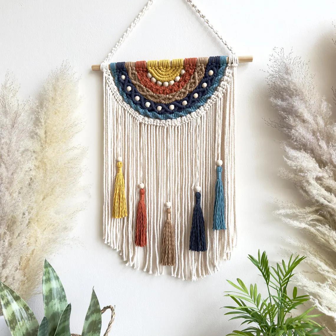 Artistic macrame wall hanging with colorful tassels and decorative elements