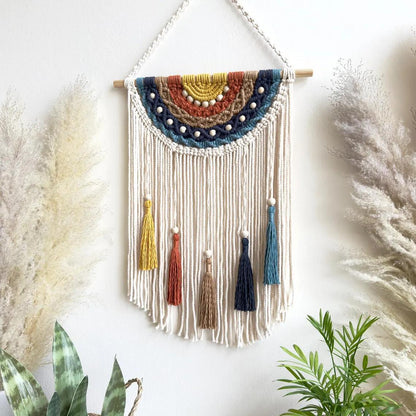 Artistic macrame wall hanging with colorful tassels and decorative elements