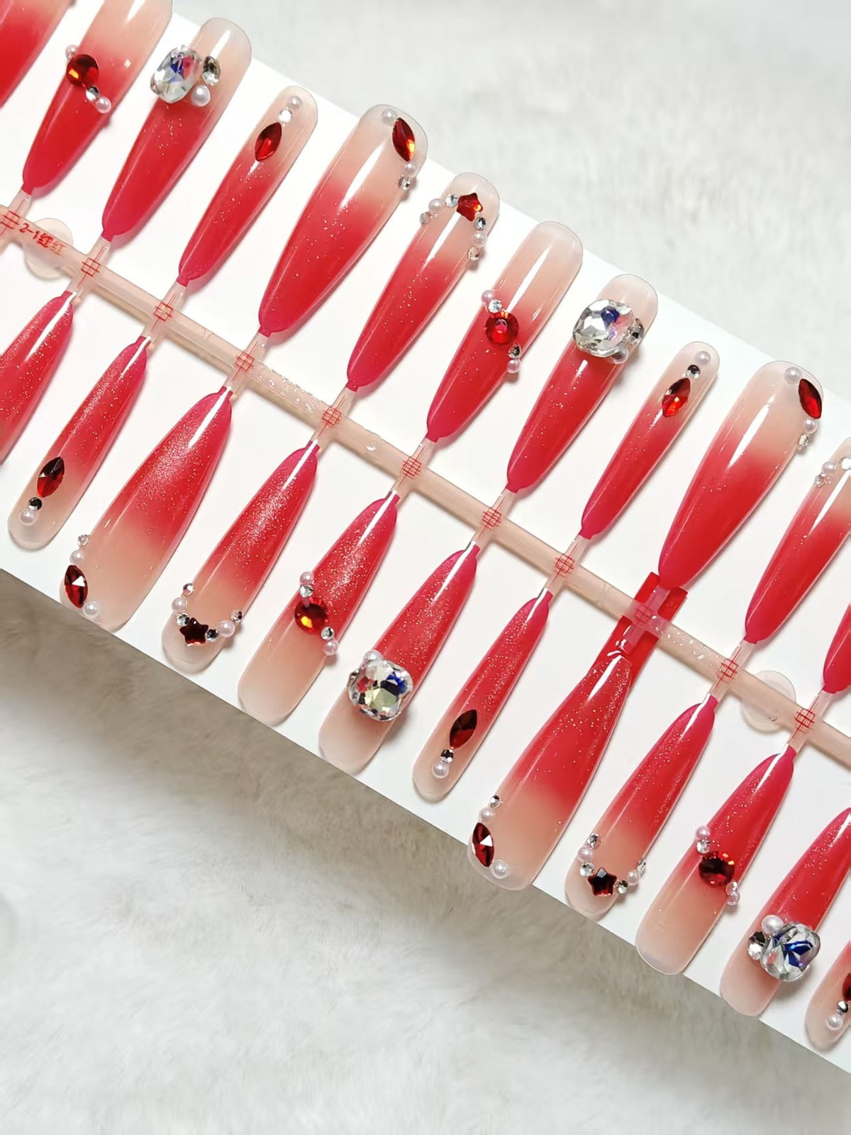 Artificial nails with glamorous glitter and rhinestone embellishments Acalora